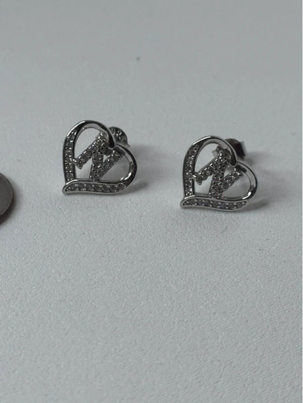 925 stamped ‘N’ earrings. Comes with rubber backs